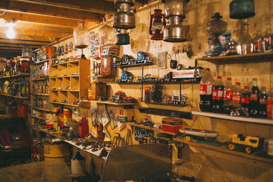 A cozy vintage workshop filled with shelves of tools, lanterns, and collectibles, creating a nostalgic atmosphere.